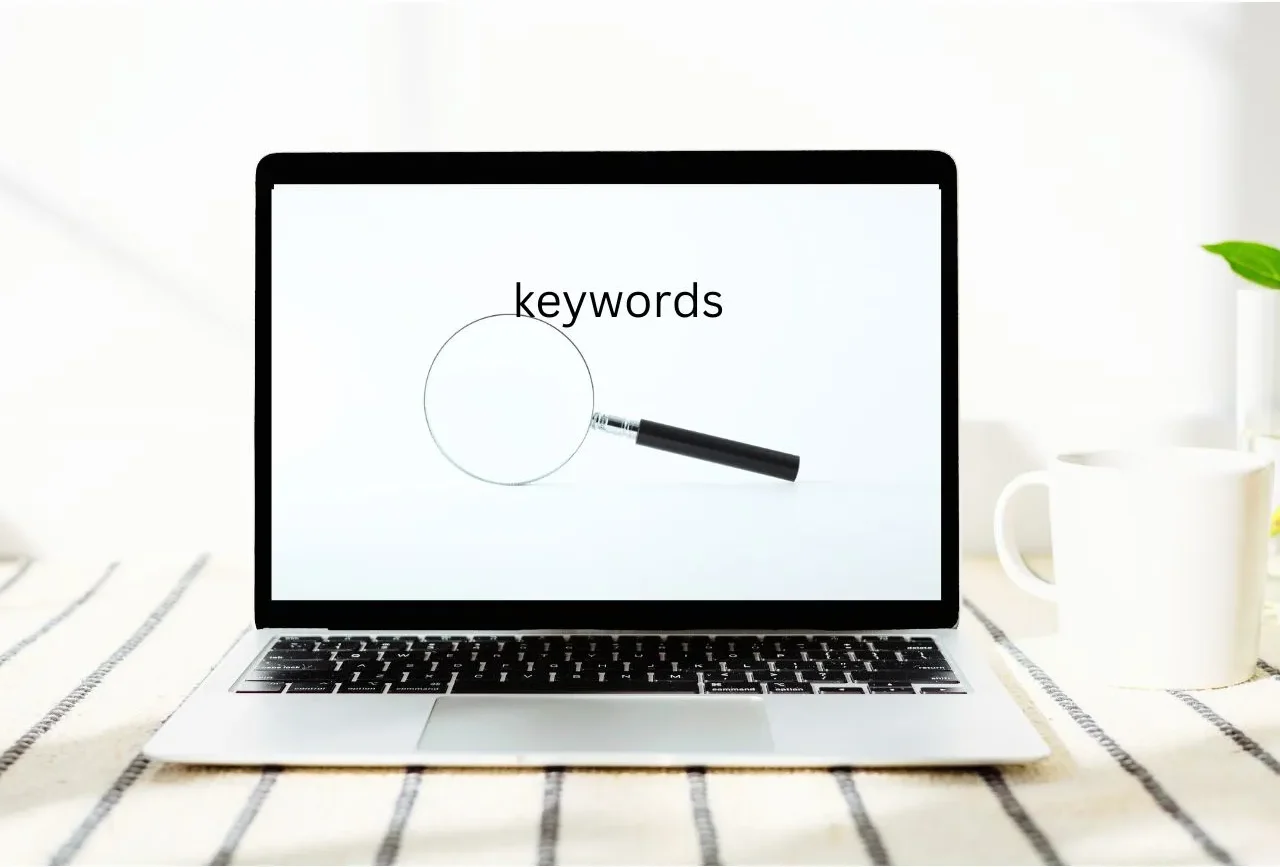 SEO specialist reviewing keyword metrics and charts on a laptop.